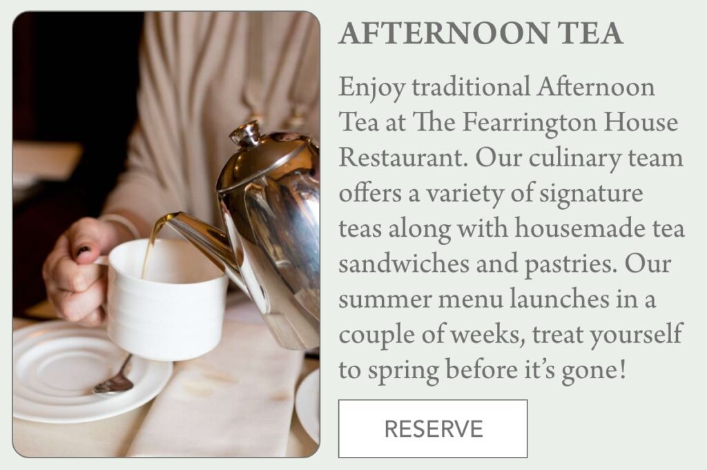 A person pours tea from a silver teapot into a white teacup on a saucer. Text advertises Afternoon Tea at The Fearrington House Restaurant and includes a "RESERVE" button. "Enjoy traditional Afternoon Tea at The Fearrington House Restaurant. Our culinary team offers a variety of signature teas along with housemade tea sandwiches and pastries. Our summer menu launches in a couple of weeks, treat yourself to spring before it’s gone!" Fearrington Village