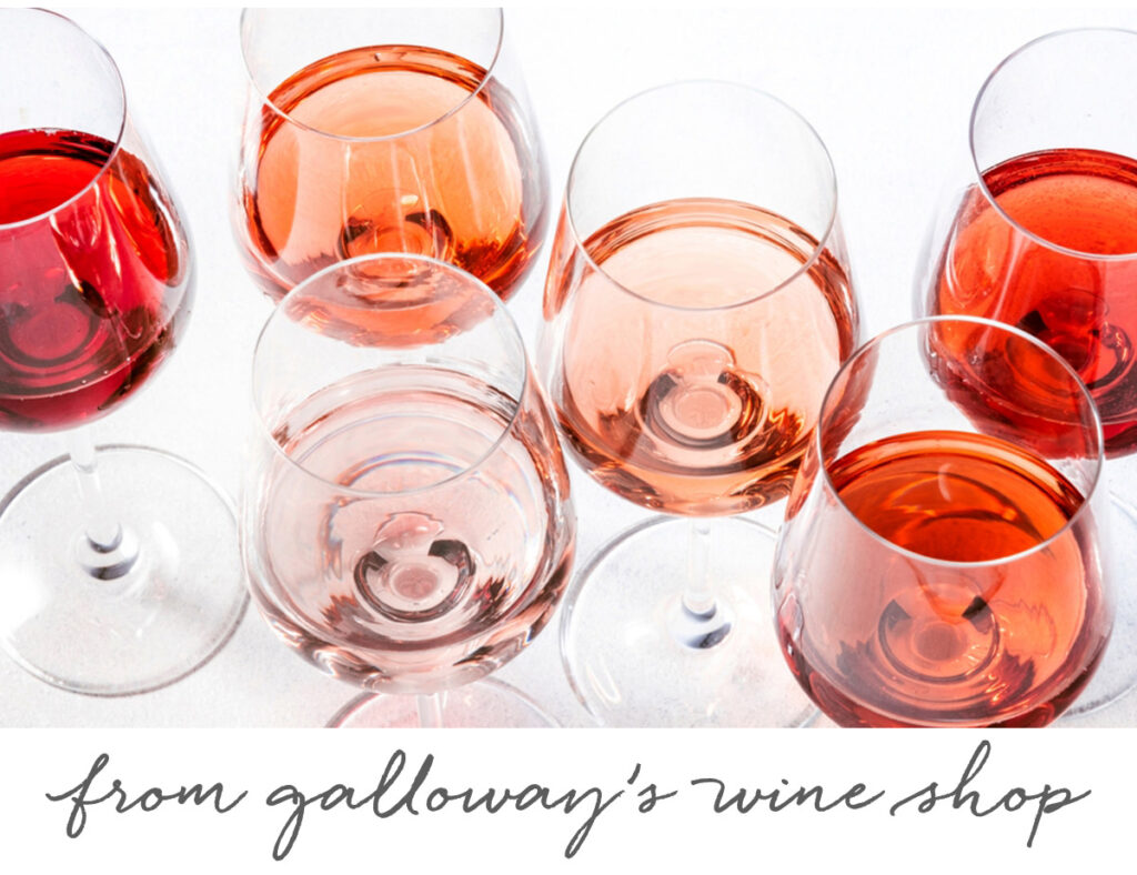 Six glasses of pink and rosé wine arranged in a cluster on a white surface, viewed from above. The text below reads "from galloway’s wine shop" in cursive writing. Fearrington Village