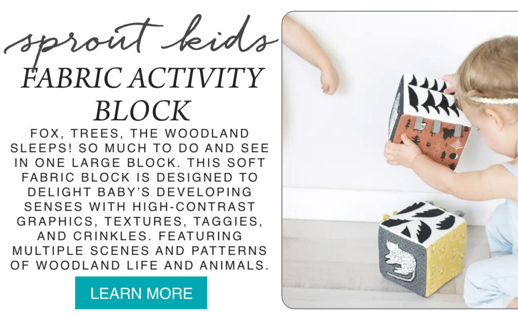 A child holds a soft fabric activity block decorated with woodland patterns; another fabric block with animals is on the floor. Text describes the block’s sensory features and woodland-themed designs for babies. Fearrington Village