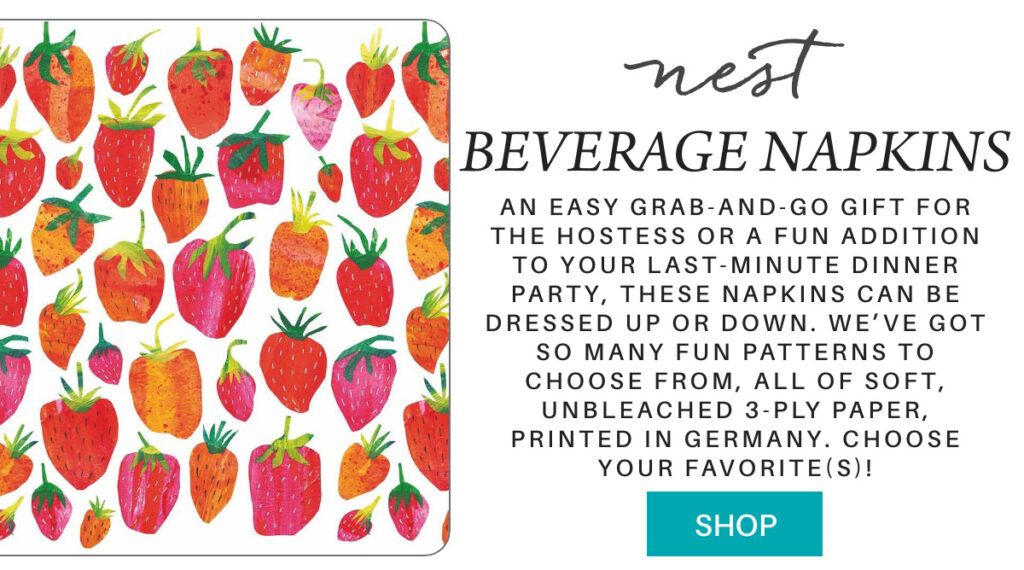 A set of beverage napkins with colorful, hand-drawn strawberries on white. Text describes the napkins as soft, unbleached, 3-ply, printed in Germany, and available in various fun patterns. A teal "Shop" button is below. "An easy grab-and-go gift for the hostess or a fun addition to your last-minute dinner party, these napkins can be dressed up or down. we’ve got so many fun patterns to choose from, all of soft, unbleached 3-ply paper, printed in germany. choose your favorite(s)!" Fearrington Village