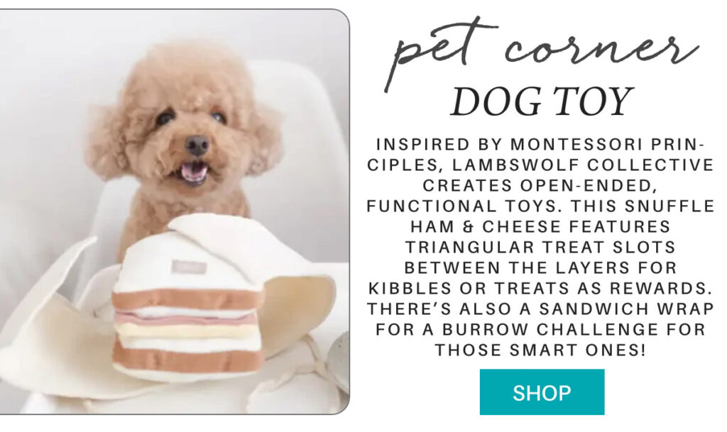 A fluffy brown dog sits next to a plush snuffle ham and cheese sandwich toy. Text beside describes it as a Montessori-inspired interactive dog toy with treat slots for kibbles or rewards."Inspired by Montessori prin-ciples, lambswolf collective creates open-ended, functional toys. This snuffle HAM & CHEESE features triangular treat slots between the layers for kibbles or treats as rewards. There’s also a sandwich wrap for a burrow challenge for those smart ones!" Fearrington Village