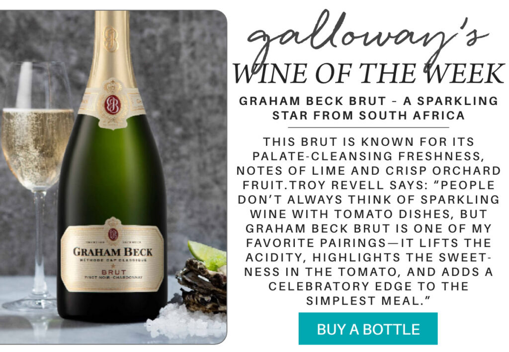 A bottle of Graham Beck Brut sparkling wine from South Africa stands beside a filled champagne flute, with ice and bubbles, next to text describing its fresh, crisp flavor and suitability for pairing with tomato dishes. "Graham Beck Brut – A Sparkling Star from South Africa. This Brut is known for its palate-cleansing freshness, notes of lime and crisp orchard fruit.troy revell says: “People don’t always think of sparkling wine with tomato dishes, but Graham Beck Brut is one of my favorite pairings—it lifts the acidity, highlights the sweet-ness in the tomato, and adds a celebratory edge to the simplest meal.” Fearrington Village