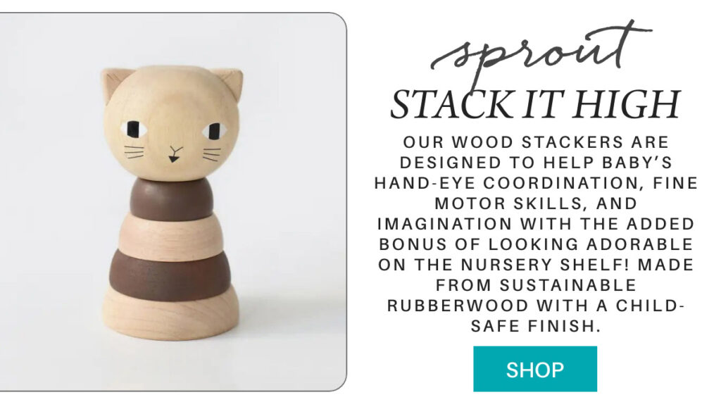A wooden cat-shaped stacker toy with neutral tones sits on a white background. Text beside describes its benefits for babies, being made from sustainable rubberwood with a child-safe finish, and includes a blue "Shop" button. "Our Wood Stackers are designed to help baby’s hand-eye coordination, fine motor skills, and imagination with the added bonus of looking adorable on the nursery shelf! Made from sustainable rubberwood with a child-safe finish." Fearrington Village