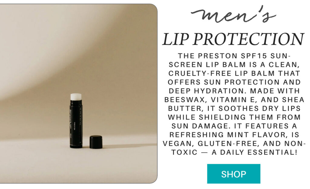 A black tube of men's SPF15 lip balm stands upright on a beige surface near a wall. Beside it, text describes the balm's sun protection, hydrating ingredients, mint flavor, and highlights its clean, vegan, and non-toxic features. "The Preston spf15 Sun-screen Lip Balm is a clean, cruelty-free lip balm that offers sun protection and deep hydration. Made with beeswax, vitamin E, and shea butter, it soothes dry lips while shielding them from sun damage. It features a refreshing mint flavor, is vegan, gluten-free, and non-toxic — a daily essential!" Fearrington Village
