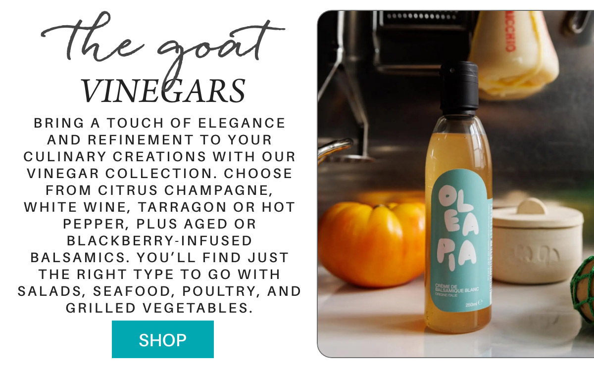 A bottle of Oleapa vinegar sits on a kitchen counter beside a yellow tomato and herbs. Text promotes a gourmet vinegar collection ideal for salads, seafood, poultry, and vegetables, with a turquoise "Shop" button below. "Bring a touch of elegance and refinement to your culinary creations with our vinegar collection. choose from citrus champagne, white wine, tarragon or hot pepper, plus aged or blackberry-infused balsamics. you’ll find just the right type to go with salads, seafood, poultry, and grilled vegetables." Fearrington Village