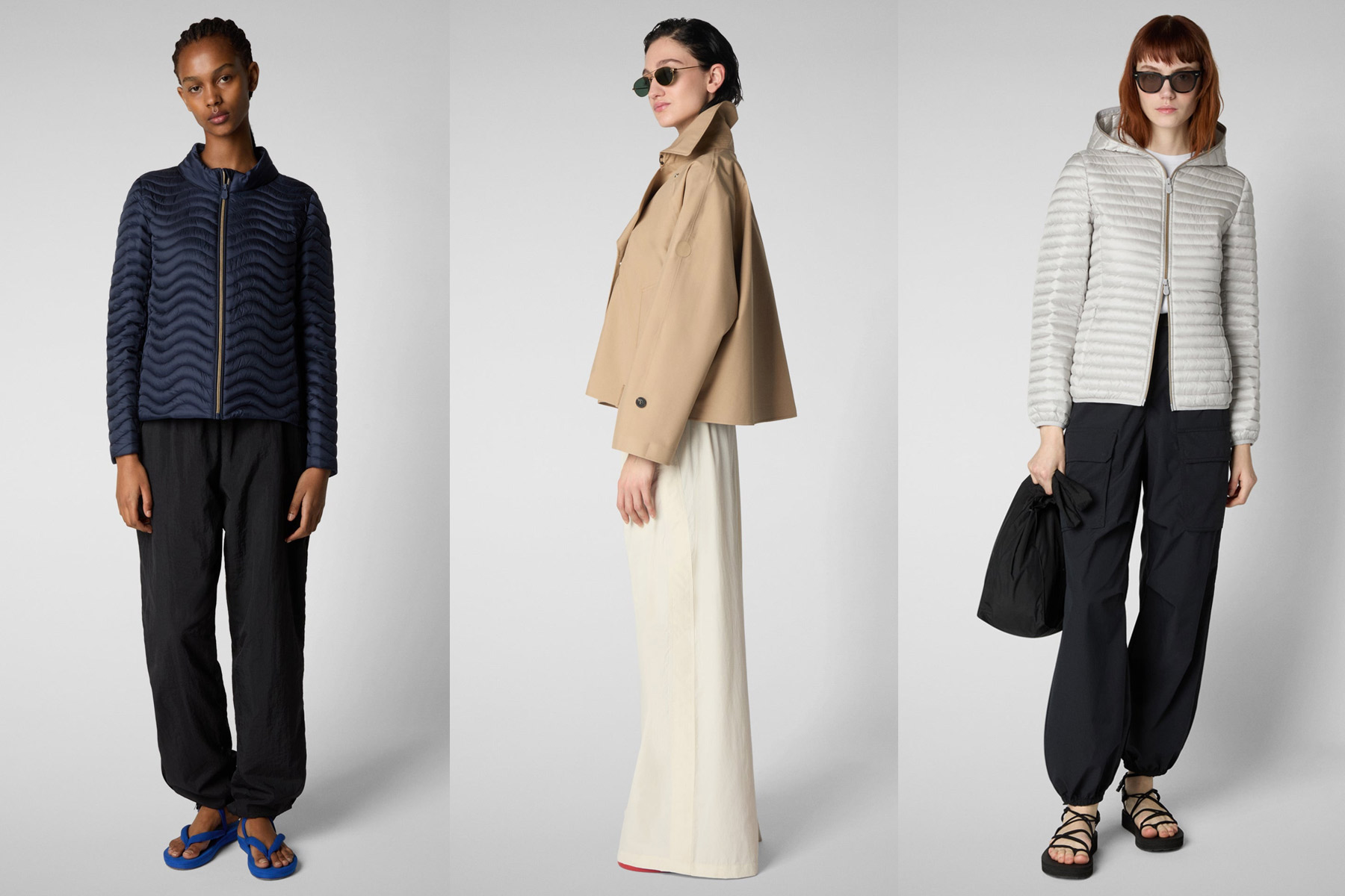 Three models pose against a plain background wearing casual outfits: a wavy navy jacket with black pants, a tan cropped jacket with wide cream pants, and a light puffer jacket with black pants and a black bag. Fearrington Village