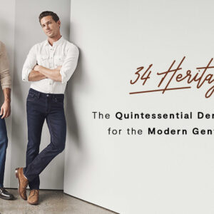 Two men in stylish denim jeans and casual tops pose against a light wall. Text reads: “34 Heritage. The Quintessential Denim Brand for the Modern Gentleman.”. Fearrington Village