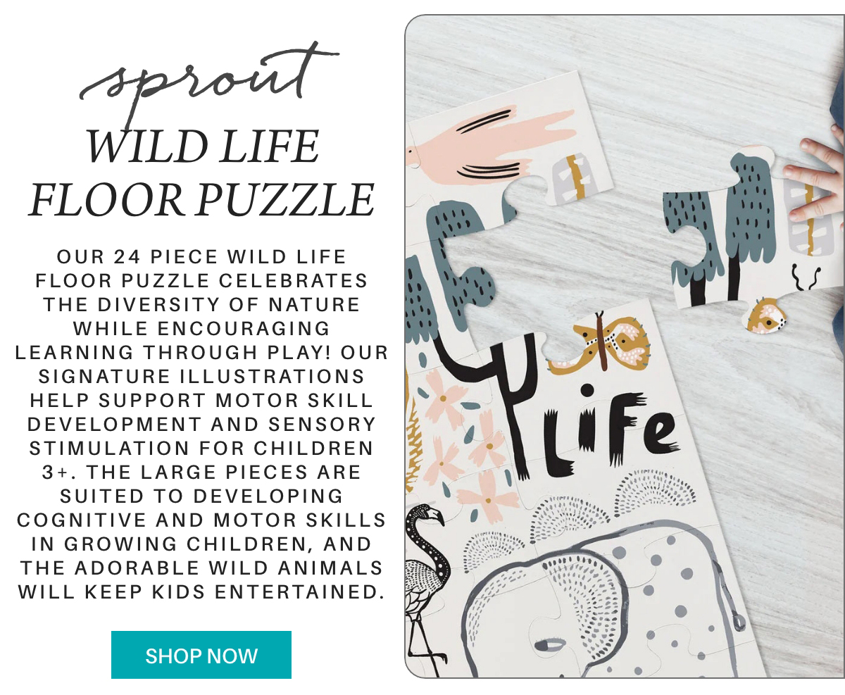 A 24-piece wildlife-themed floor puzzle with illustrated animal and tree pieces is partially assembled on a white surface. Text describes the puzzle’s benefits for children’s motor skills and learning. A blue "Shop Now" button is visible. Fearrington Village "Our 24 piece Wild Life Floor Puzzle celebrates the diversity of nature while encouraging learning through play! Our signature illustrations help support motor skill development and sensory stimulation for children 3+. The large pieces are suited to developing cognitive and motor skills in growing children, and the adorable wild animals will keep kids entertained."