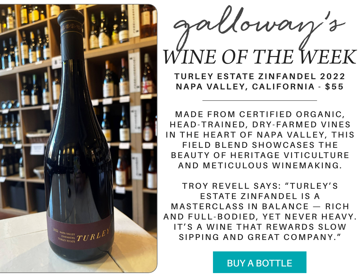 A bottle of Turley Estate Zinfandel wine sits on a wooden table in a wine shop, with shelves of wine bottles in the background. Text highlights the wine’s origin, tasting notes, price, and a “Buy a Bottle” button. Fearrington Village "Made from certified organic, head-trained, dry-farmed vines in the heart of Napa Valley, this field blend showcases the beauty of heritage viticulture and meticulous winemaking. Troy revell says: “Turley’s Estate Zinfandel is a masterclass in balance — rich and full-bodied, yet never heavy. It’s a wine that rewards slow sipping and great company.”